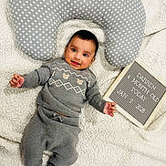 Darren joined the competition — help win amazing prizes! baby, infant, child, smiling, gray_clothing, knitwear, polka_dot_pillow, white_blanket, letter_board, milestone, portrait, cute, lying_down, cozy, happy, indoors, soft_texture, warm, childhood, baby_photography
