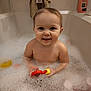 Carlie is registered to the contest to win money with this photo: baby, bathtub, bubbles, foam, child, toy, smile, water, towel, bathroom, skin, head, face, happy, playing, indoor, young, clean, cute, person