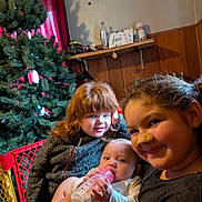 Carl joined the competition — help win amazing prizes! child, baby, indoor, christmas_tree, bottle, smiling, bandage, curly_hair, red_hair, sweater, curtain, wood_paneling, shelf, bottle_feeding, playpen, family, toddler, girl, infant, home