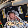 baby, infant, sleeping, car_seat, blanket, chicco, outdoor, nature, sunlight, soft_texture, peaceful, child, newborn, cozy, resting, cushion, fabric, portrait, cute, relaxed