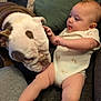 Pennelopea is registered to the contest to win money with this photo: baby, bulldog, dog, infant, couch, onesie, curious, interaction, pets, child, face, animal, cute, wrinkled, tongue, furniture, indoor, legs, skin, head
