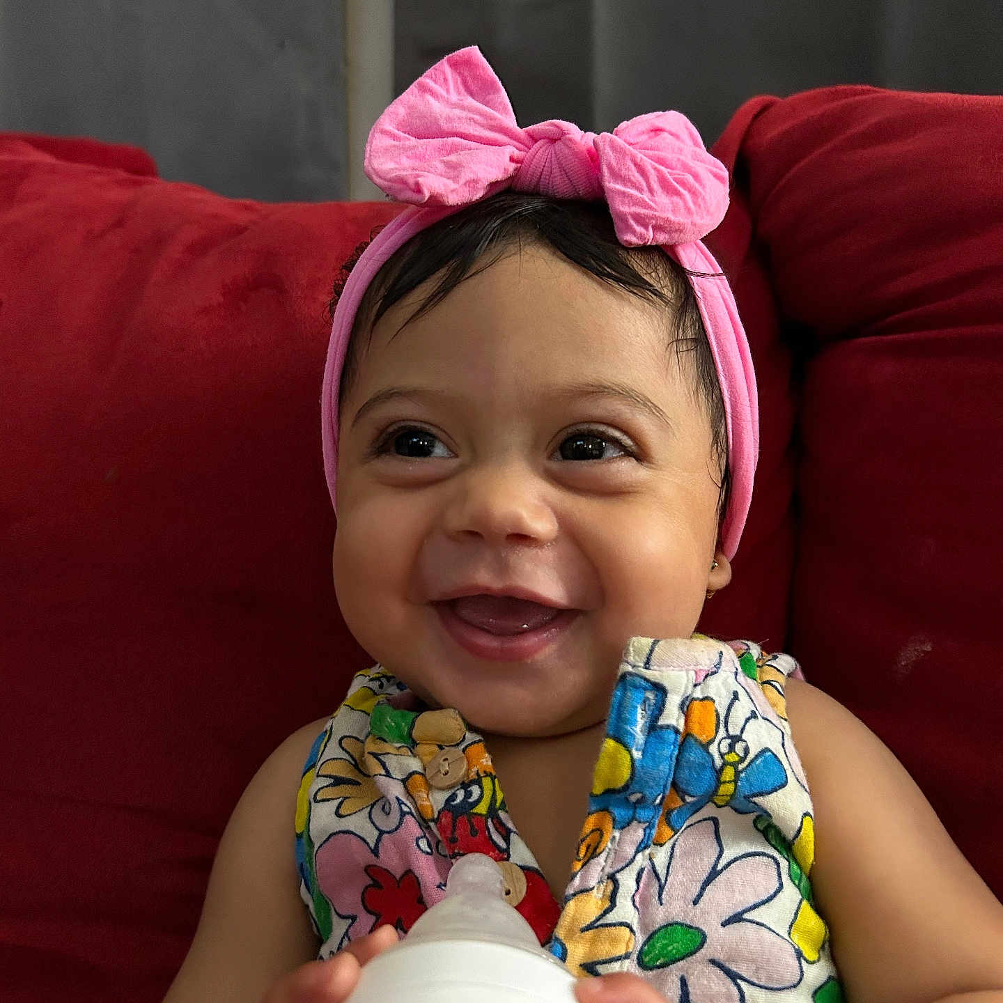 Myla is registered to the contest to win money with this photo: accessories, architecture, baby, beverage, bodypart, bottle, couch, cushion, face, finger, furniture, hand, happy, head, homedecor, milk, person, photography, portrait, smile