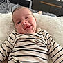 Maximillian joined the competition — help win amazing prizes! baby, infant, striped_clothing, smile, wink, face, cute, lying_down, blanket, indoor, home, furniture, couch, cozy, soft_texture, child, person, happy, young, portrait