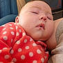 Aurora is registered to the contest to win money with this photo: baby, sleeping, polka_dot, red_clothing, child, face, close_up, cozy, indoor, resting, person, furniture, arm, casual, comfort, infant, peaceful, soft, nap, cute