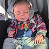 Briar is registered to the contest to win money with this photo: baby, infant, sleeping, car_seat, vehicle, portrait, plaid, hood, clothing, sneakers, pacifier, toy, seatbelt, sunlight, indoors, face, closed_eyes, peaceful, child, photography