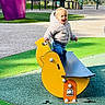 casual, child, daytime, duck_shape, fun, green_turf, happy, jacket, outdoor, park, person, play, playground, recreation, rocker, smiling, sunlight, toddler, toy, yellow