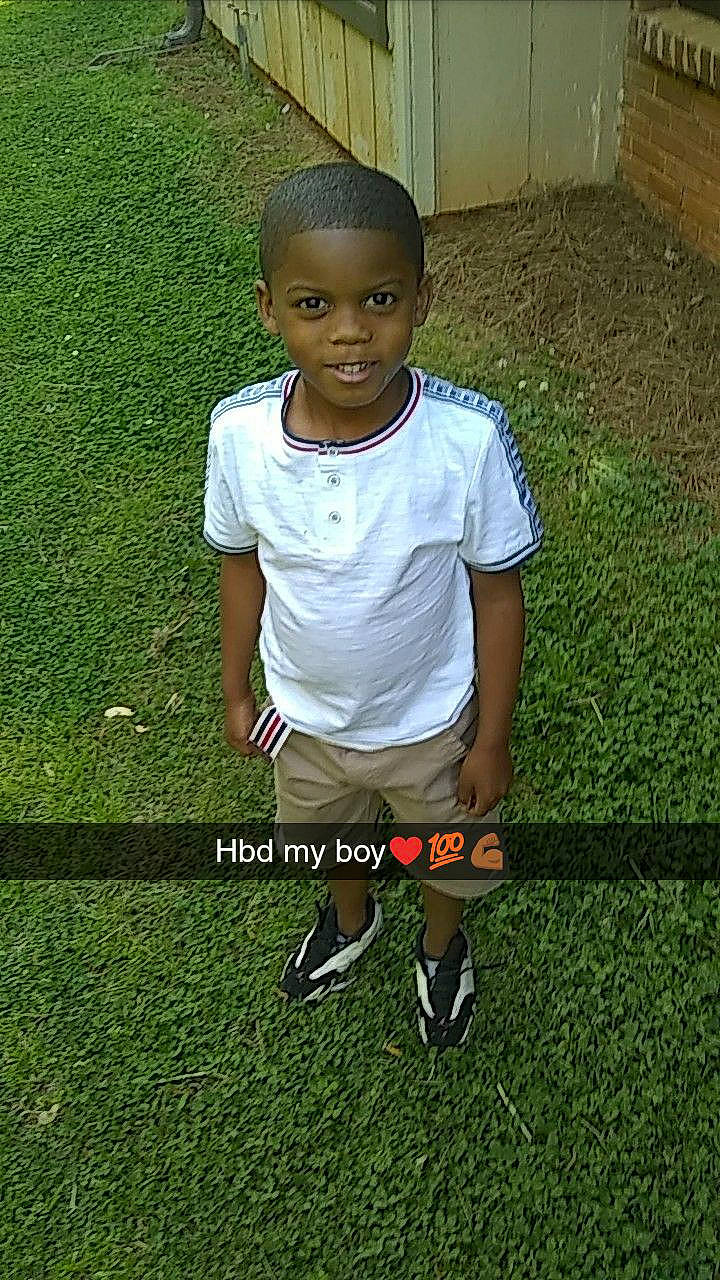 Brayland joined the competition — help win amazing prizes! child, football_player, footwear, grass, lawn, person, play, player, shoe, sitting, smile, soccer_ball, t_shirt, toddler