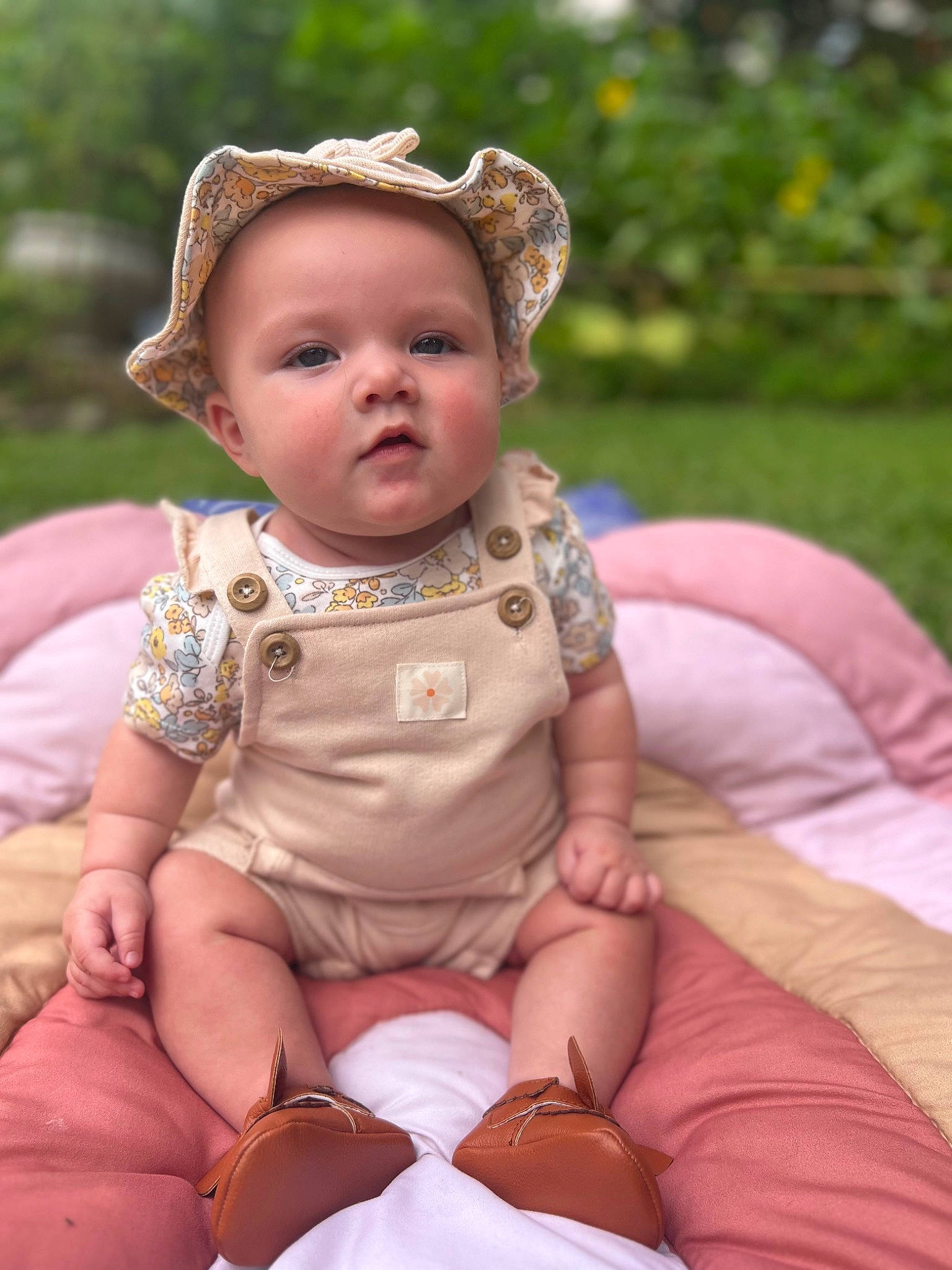 Griffin joined the competition — help win amazing prizes! baby, baby_toddler_clothing, cheek, child, fashion_accessory, fun, grass, happy, head, human_leg, jewellery, lip, pattern, person, pink, sitting, skin, sun_hat, thigh, toddler
