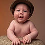 baby, cap, cheeks, child, cute, expression, face, fingers, hands, hat, indoor, infant, knitwear, portrait, skin, smile, soft, texture, warm, young