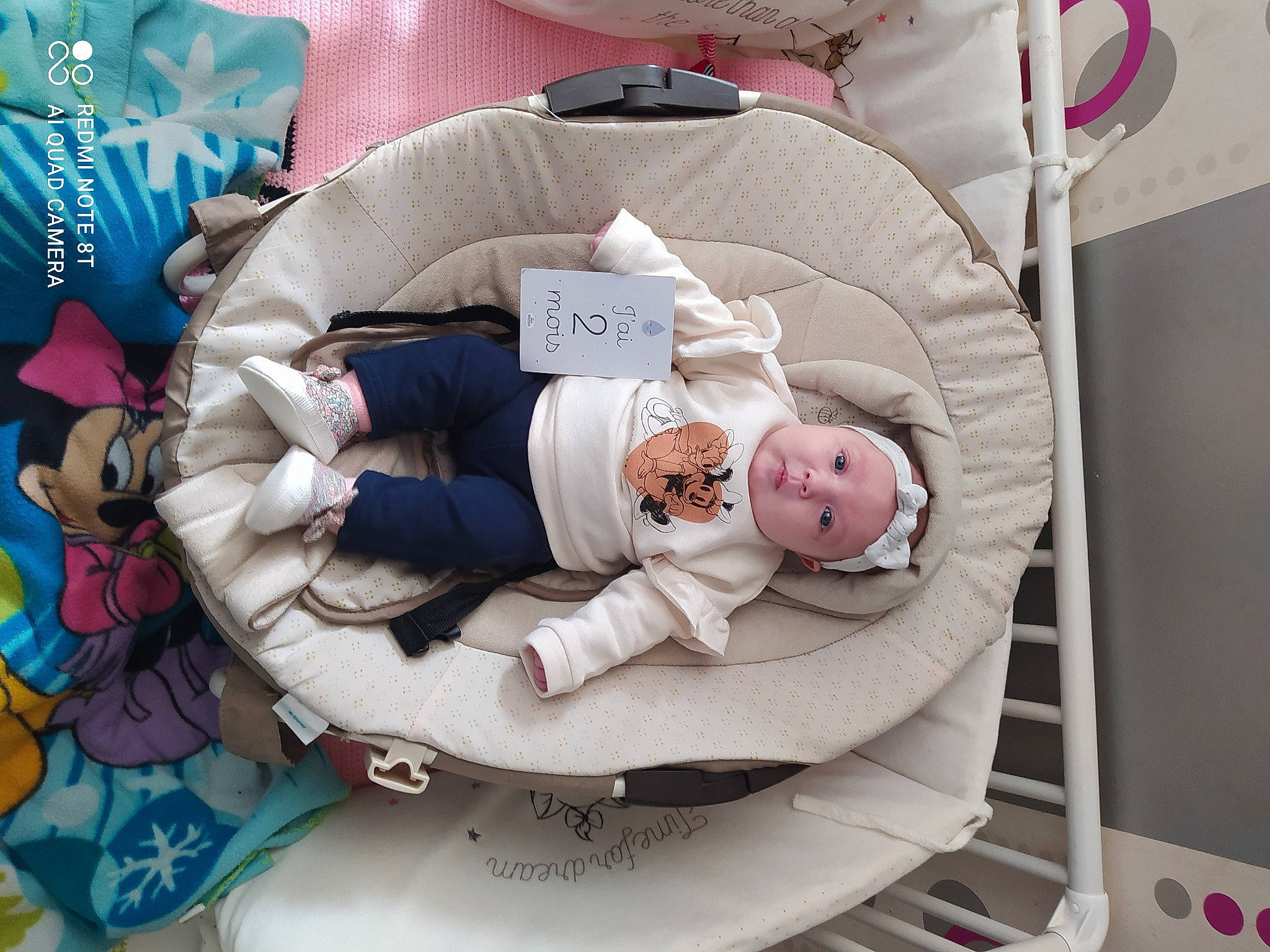 Angèla a rejoint le concours — aidez-le/la à gagner de superbes lots ! baby, baby_products, baby_sleeping, baby_toddler_clothing, baby_toys, bed_sheet, bedding, bedroom, carmine, child, comfort, headwear, linens, pattern, person, pink, plush, room, sleeve, smile