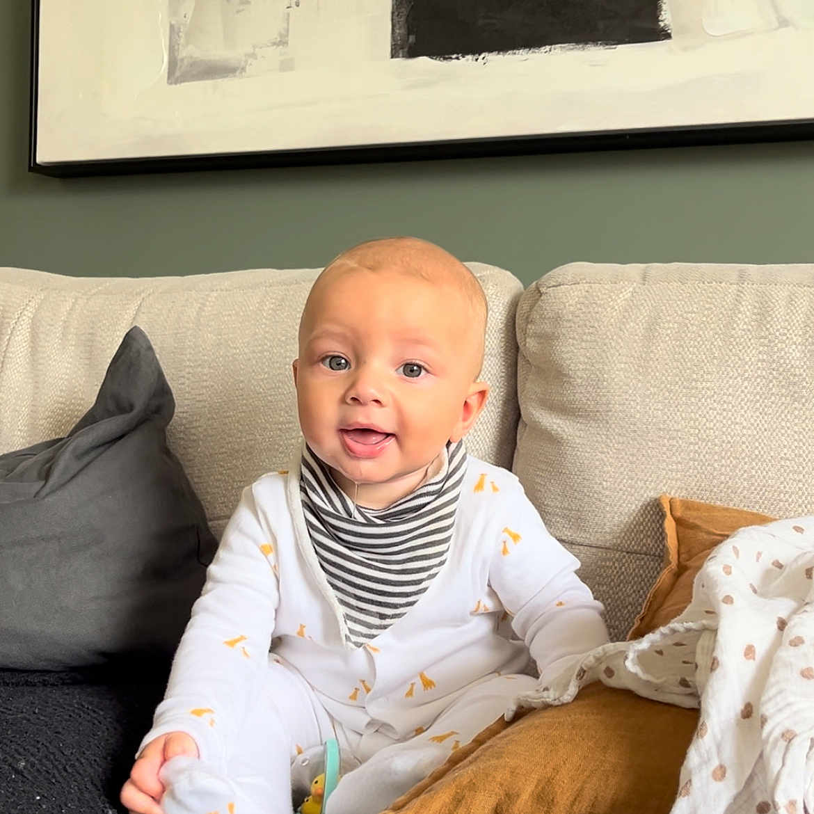 Lennox joined the competition — help win amazing prizes! architecture, baby, babylaughing, building, clothing, couch, cushion, face, furniture, happy, head, homedecor, indoors, livingroom, person, photography, portrait, room, sitting, smile