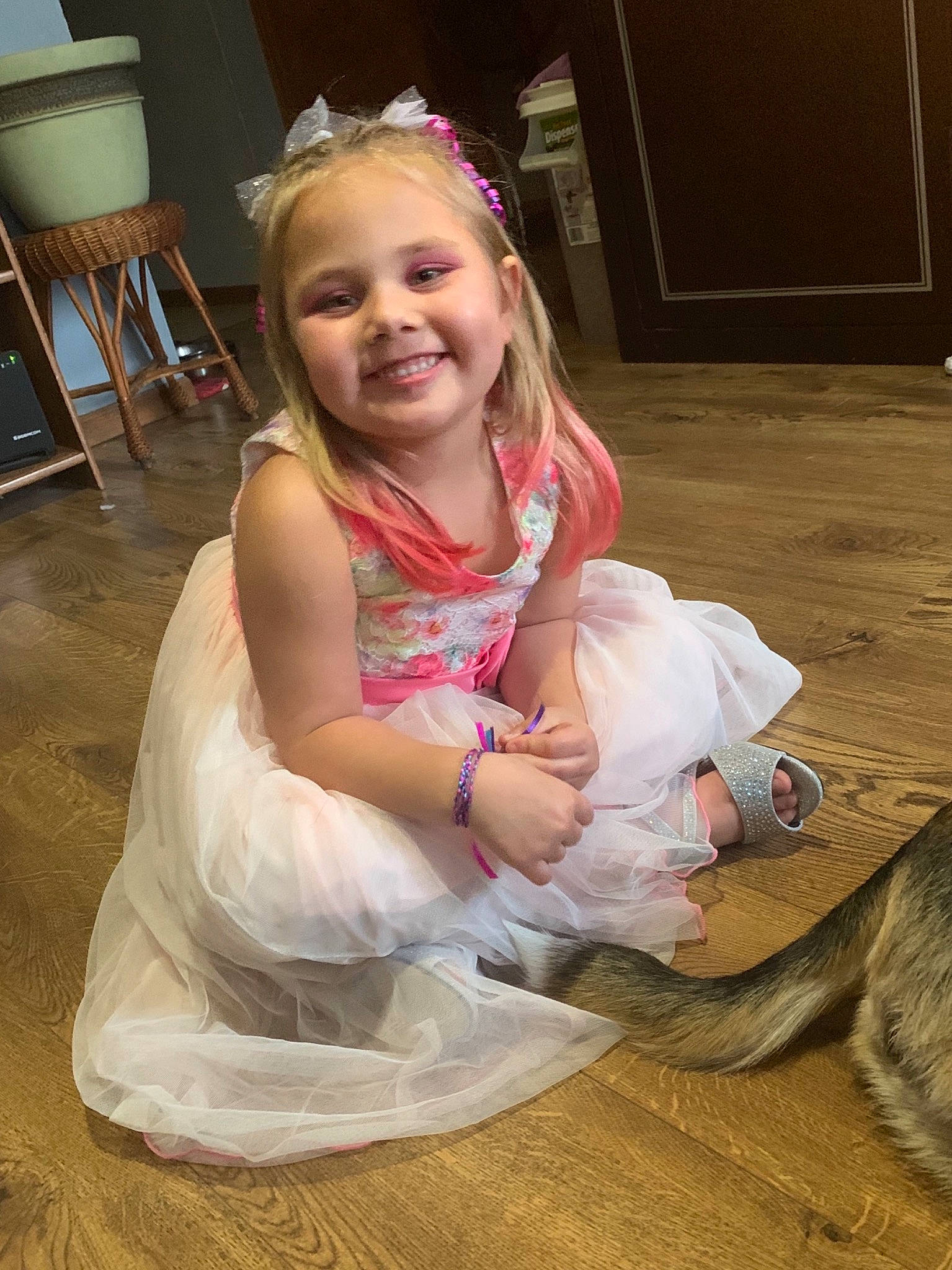 Milly is registered to the contest to win money with this photo: baby, baby_toddler_clothing, cat, child, child_model, day_dress, dress, embellishment, felidae, foot, fur, hair_accessory, headband, headpiece, joy, lamp, person, pink, small_to_medium_sized_cats, stool