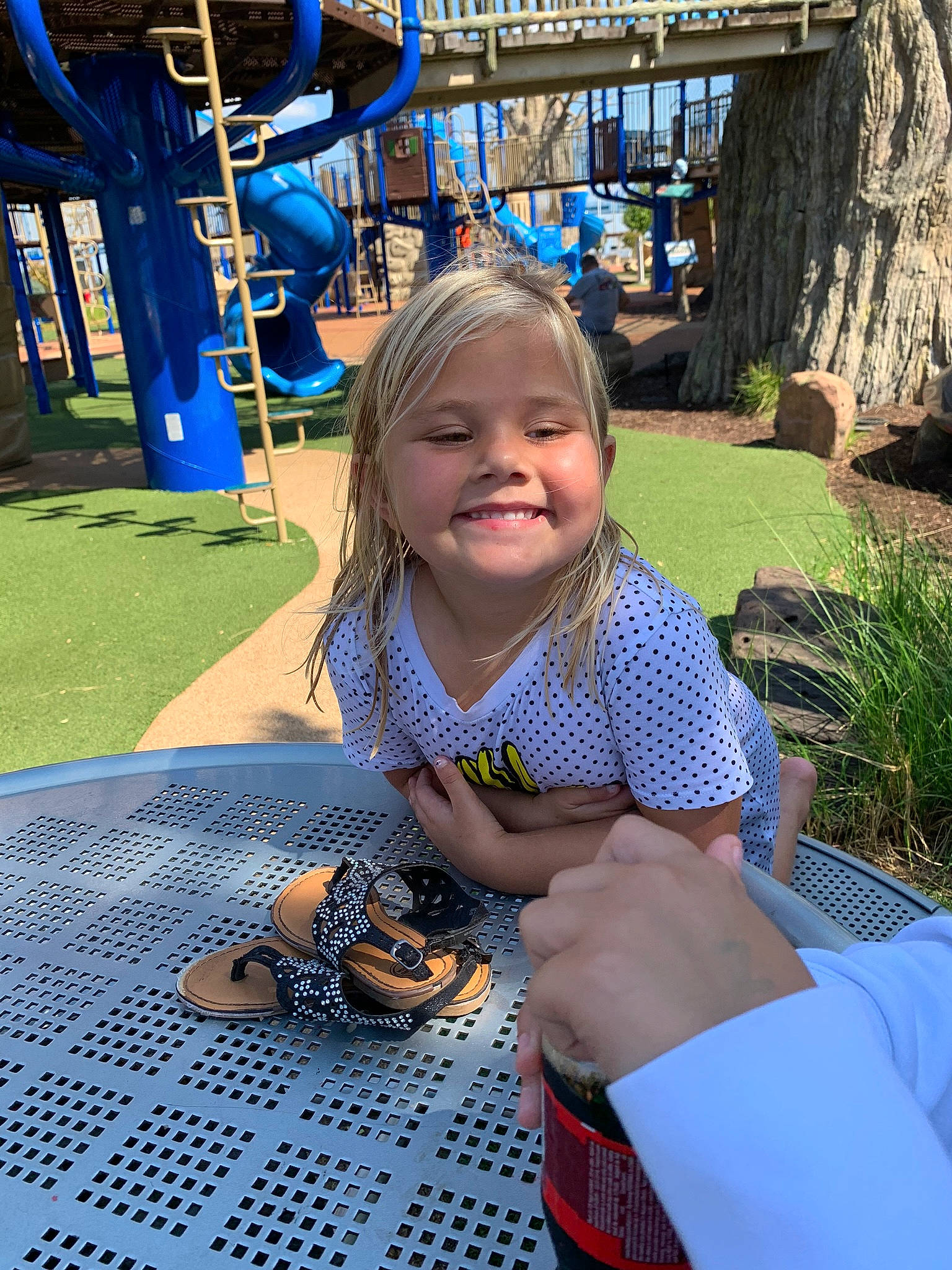 Milly is registered to the contest to win money with this photo: blue, child, electric_blue, event, fun, grass, happy, joy, leisure, pattern, person, plant, playground, public_space, recreation, sitting, smile, t_shirt, textile, toddler