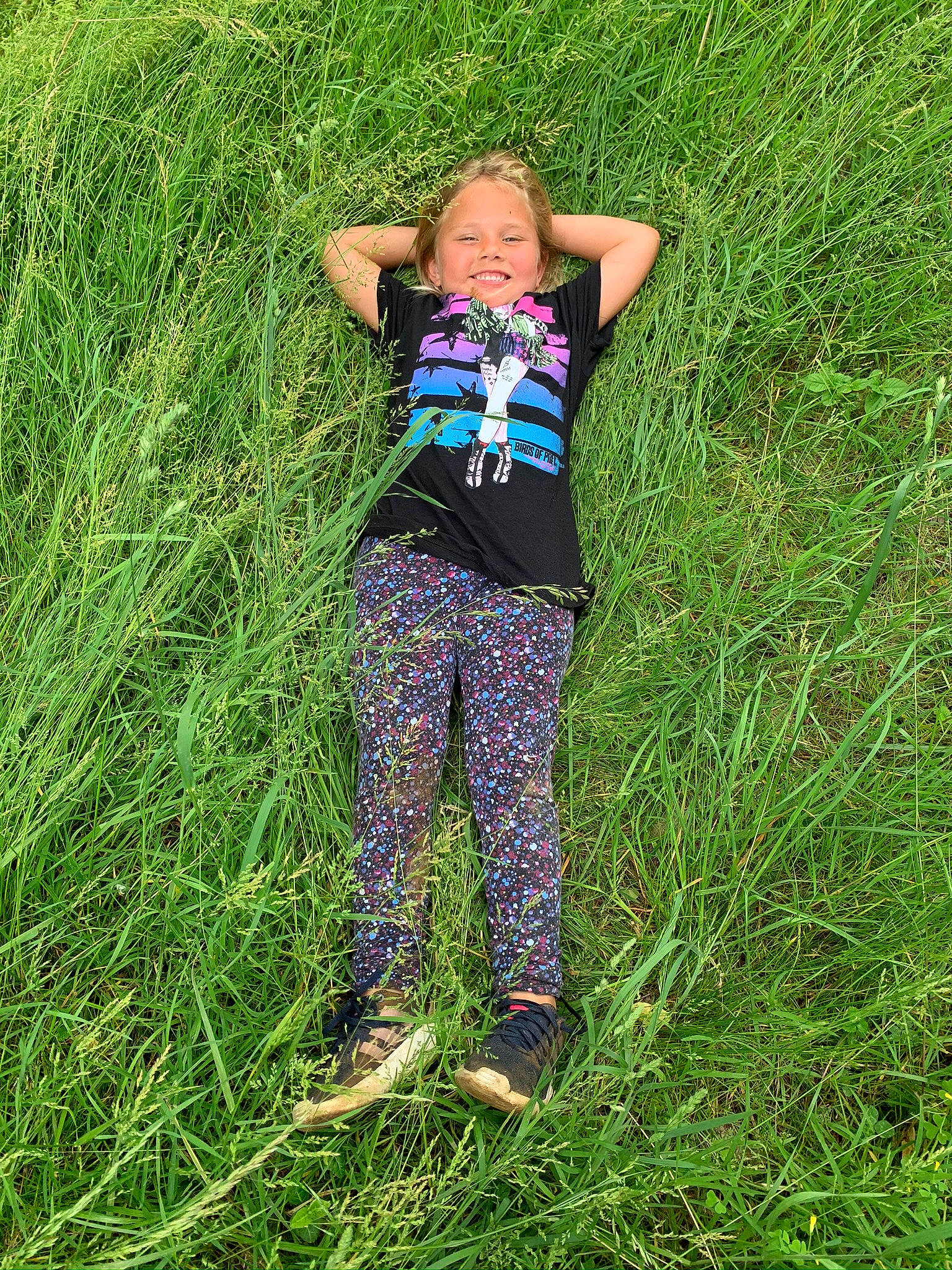 Milly is registered to the contest to win money with this photo: agriculture, child, denim, electric_blue, field, fun, grass, grass_family, grassland, happy, joy, lawn, leisure, meadow, people_in_nature, person, plant, prairie, soil, t_shirt