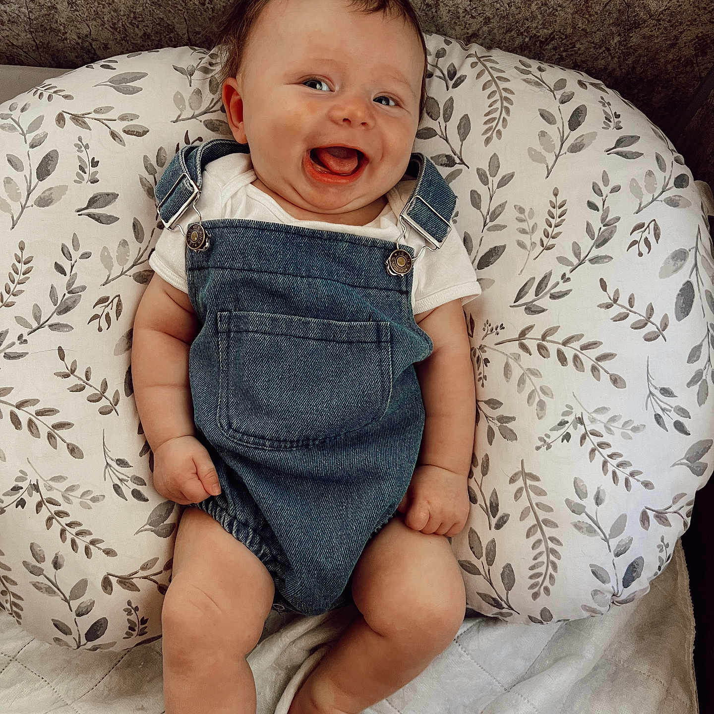 Kohen is registered to the contest to win money with this photo: baby, babylaughing, clothing, couch, cushion, face, furniture, happy, head, homedecor, jeans, laughing, newborn, pants, person, photography, portrait, shorts, sitting, smile