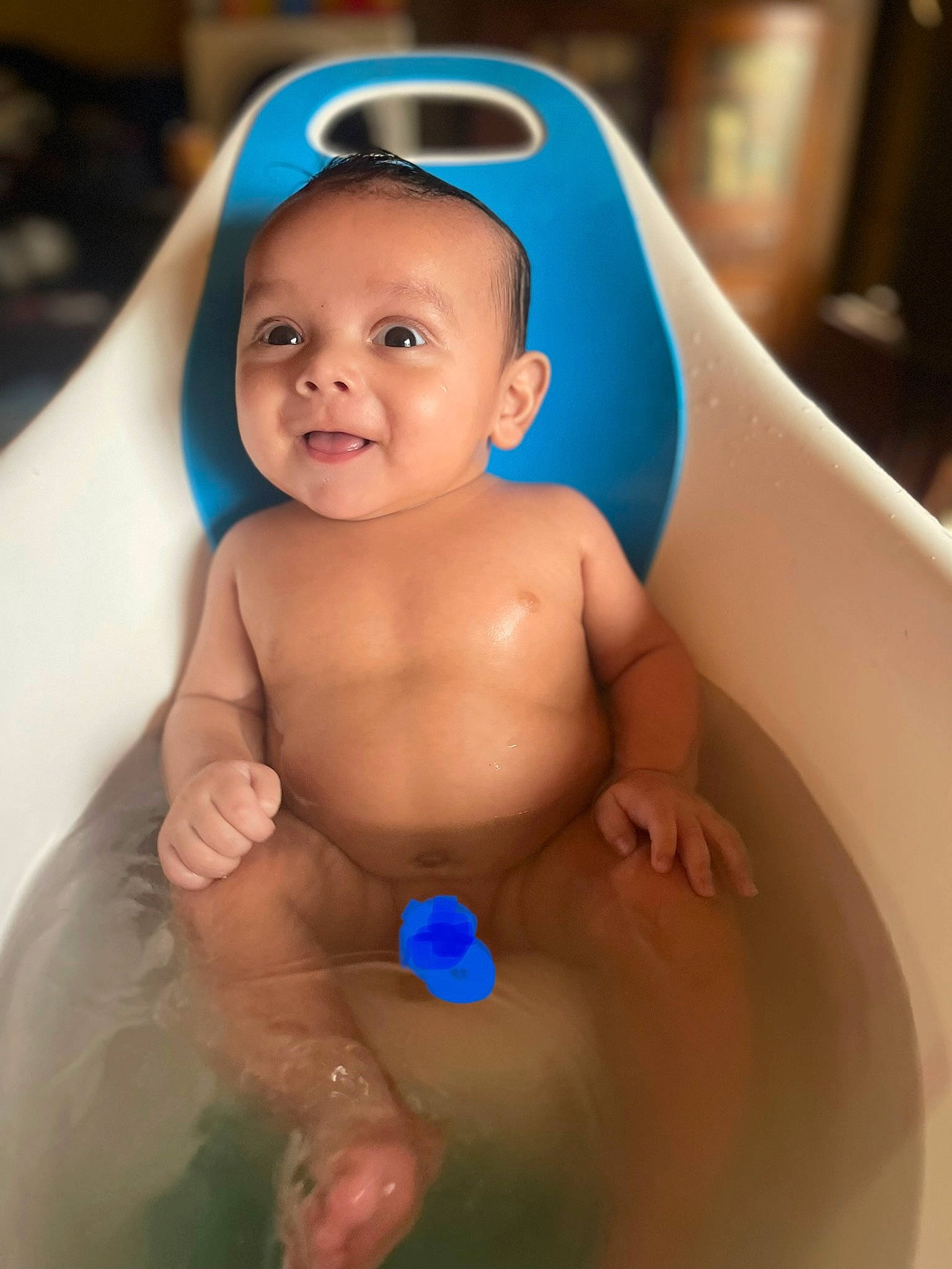 Brodie is registered to the contest to win money with this photo: arm, baby, baby_bathing, bathing, bathroom, bathtub, blue, cheek, eye, face, finger, fluid, human_body, iris, liquid, muscle, person, skin, smile, toddler