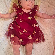 Chloe is registered to the contest to win money with this photo: baby, child, infant, portrait, lying_down, smiling, happy, dress, burgundy, bow, headband, butterfly, blanket, bed, nursery, indoor, face, arms_outstretched, photography, adorable