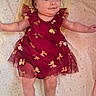 baby, child, infant, portrait, lying_down, smiling, happy, dress, burgundy, bow, headband, butterfly, blanket, bed, nursery, indoor, face, arms_outstretched, photography, adorable
