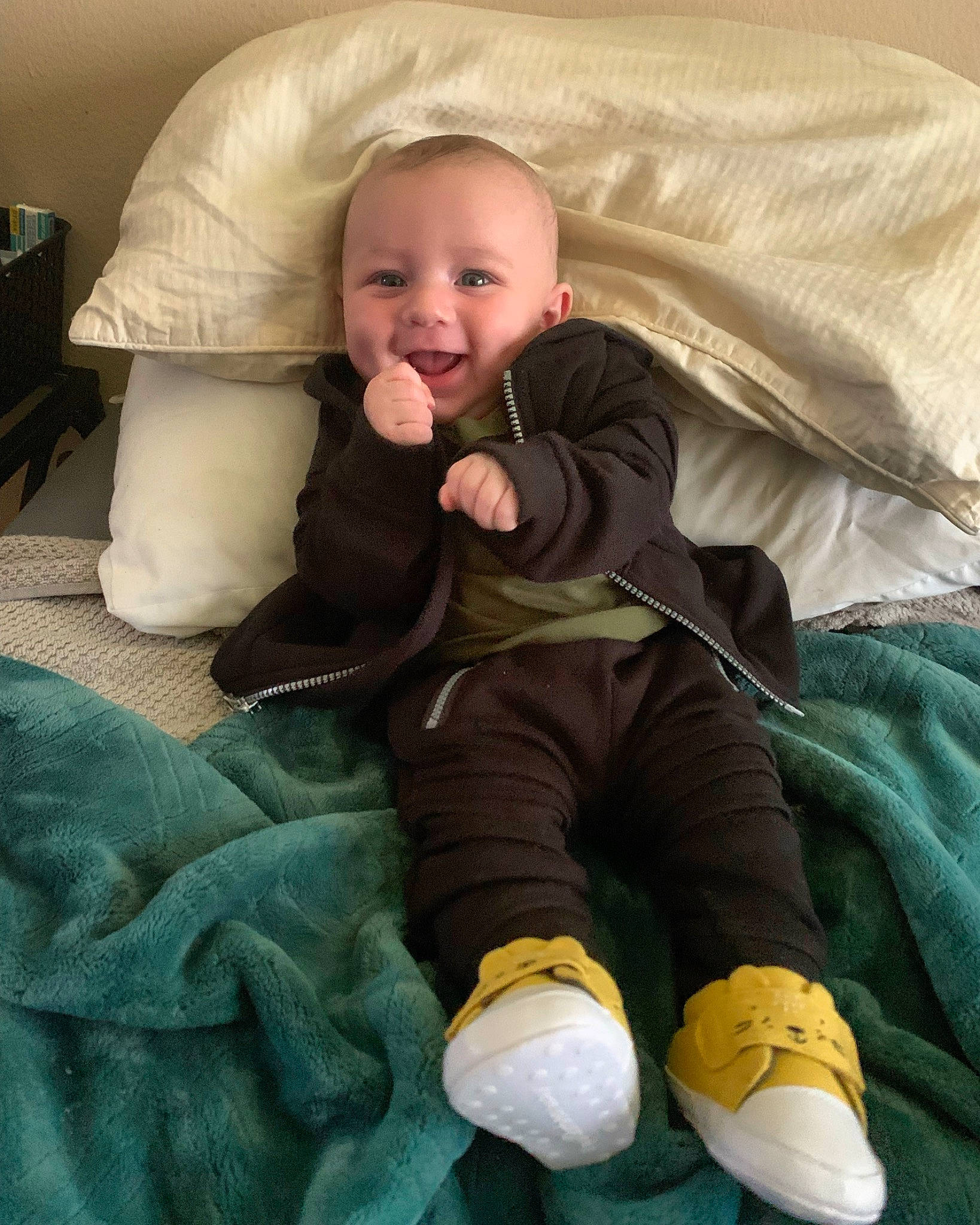 Elijah joined the competition — help win amazing prizes! baby, baby_toddler_clothing, cheek, child, comfort, face, finger, green, head, lap, leg, linens, mouth, person, sitting, skin, smile, sock, textile, toddler
