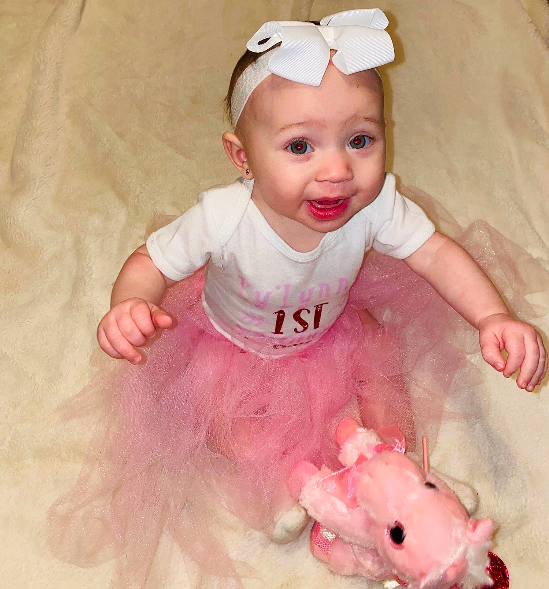 Tylynn is registered to the contest to win money with this photo: baby, baby_toddler_clothing, cheek, child, eye, facial_expression, fashion_accessory, fun, happy, head, headband, headpiece, headwear, jewellery, mammal, person, pink, skin, sleeve, smile