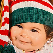 Camelya participe au concours pour gagner de l'argent avec cette photo : baby, smiling, face, hat, knit_hat, pom_pom, cheeks, infant, cute, holiday, festive, red, white, green, clothing, portrait, closeup, warm, happy, child