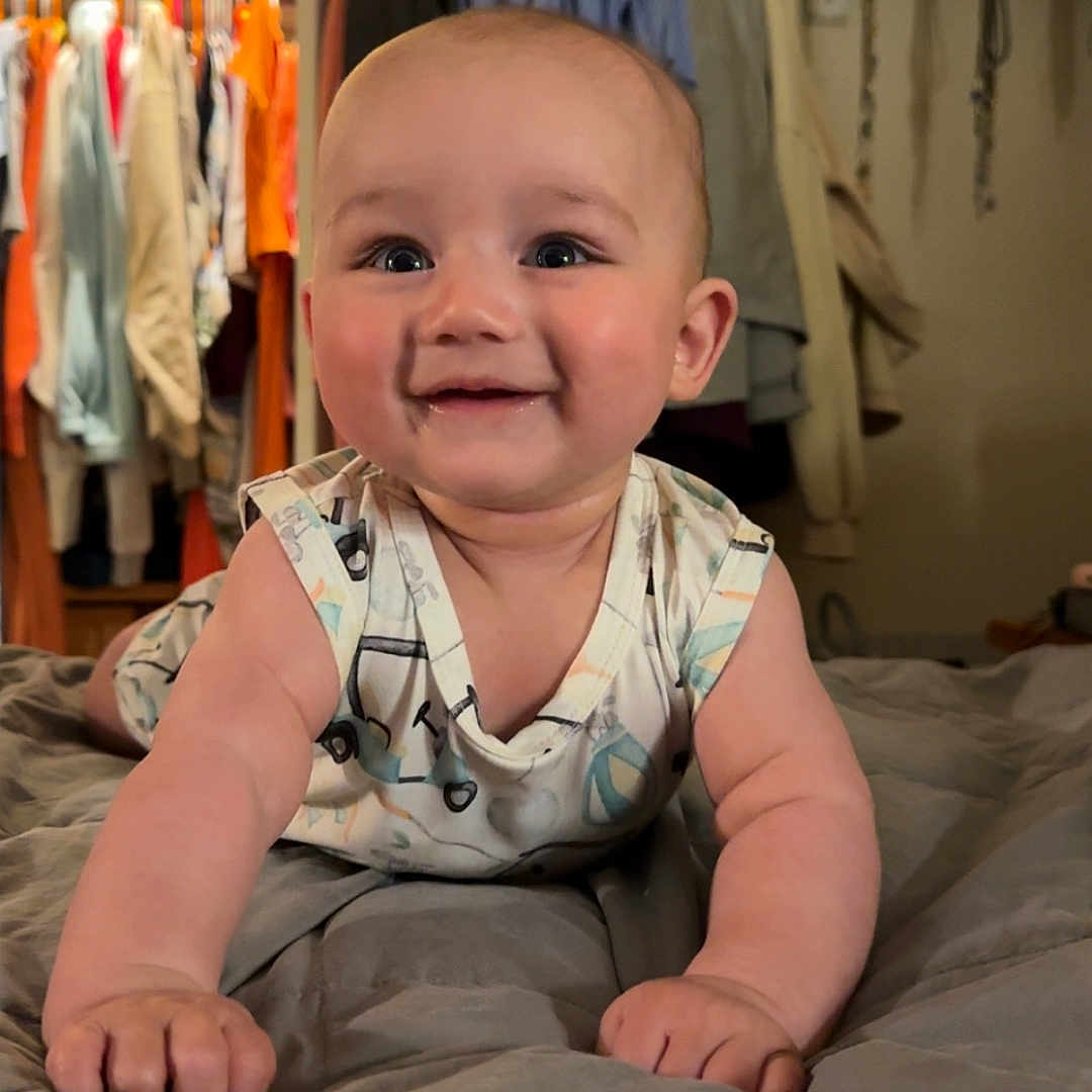 Stratton joined the competition — help win amazing prizes! baby, bodypart, clothing, coat, crawling, face, finger, furniture, hand, head, homedecor, indoors, linen, pants, person, photography, portrait, shelf, sitting, wood