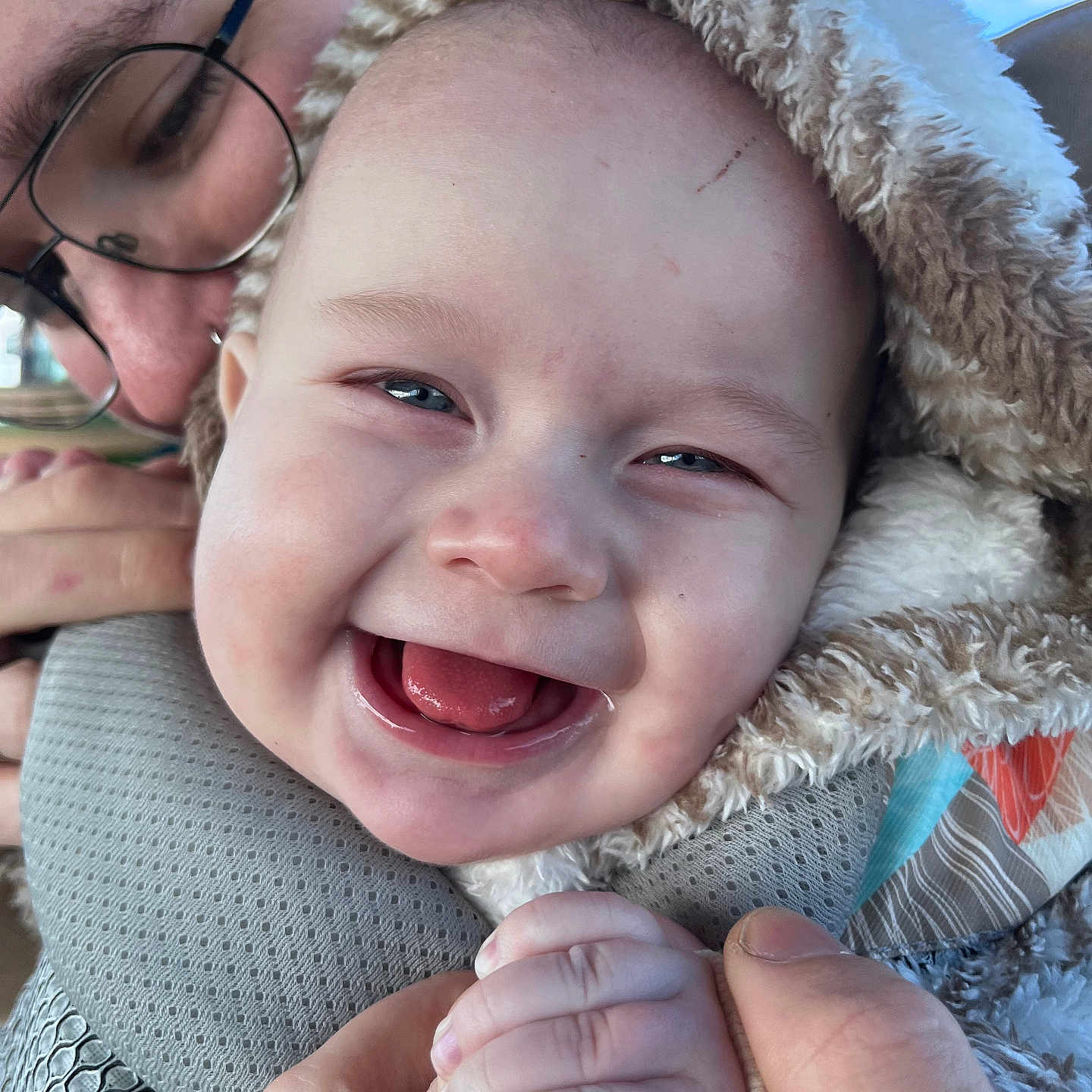 Obi is registered to the contest to win money with this photo: accessories, baby, bodypart, clothing, coat, face, finger, glasses, hand, happy, hat, head, jacket, laughing, mouth, person, photography, portrait, smile, teeth