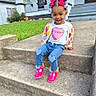 toddler, child, smile, pink_bow, jeans, heart_patch, cardigan, steps, sidewalk, grass, house, porch, outdoor, daylight, cute, happy, portrait, sitting, fashion, accessories