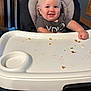 Kaysen joined the competition — help win amazing prizes! baby, high_chair, smile, food_crumbs, messy, indoor, child, toddler, clothing, face, person, happy, seat, table, wood, floor, footwear, sock, feeding, graco