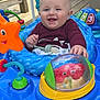 Kaysen joined the competition — help win amazing prizes! baby, child, smiling, blue_activity_walker, toy, orange_star, red_crab, outdoor, wooden_deck, greenery, playtime, happy, infant, clothing, sitting, colorful, face, person, cute, daylight