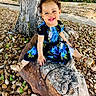 Neriah is registered to the contest to win money with this photo: toddler, child, smiling, happy, curly_hair, pigtails, blue_dress, floral_pattern, golden_shoes, rock, pebbles, tree_trunk, outdoor, nature, greenery, house, sunlight, portrait, sitting, playful