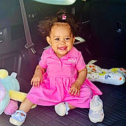 Neriah joined the competition — help win amazing prizes! toddler, child, smile, pink_dress, baby_bottle, car_interior, seatbelt, soft_toys, happy, sitting, cute, hair_bun, earrings, footwear, playful, portrait, indoors, car_seat, baby, colorful