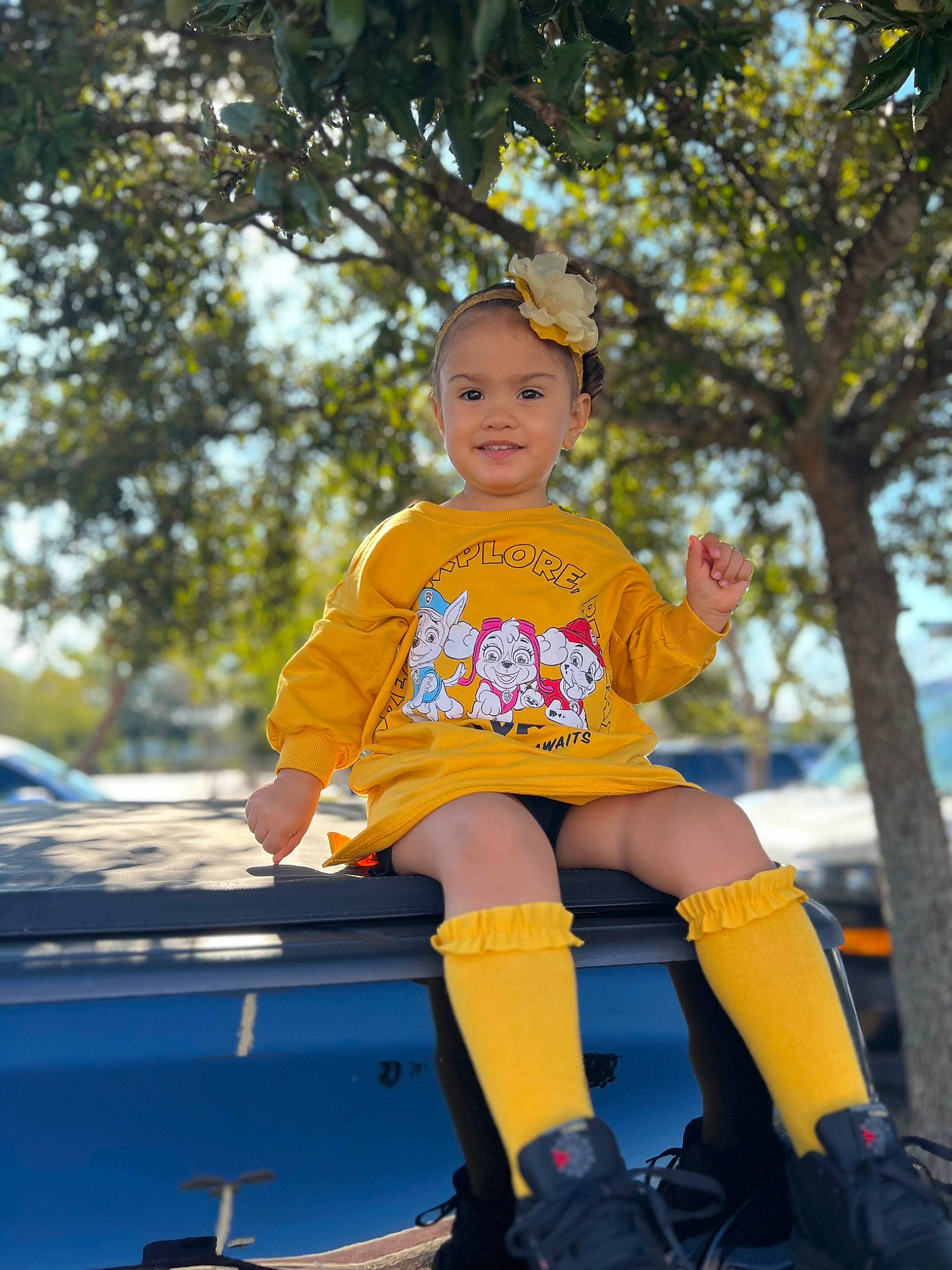 Alia Rodriguez is registered to the contest to win money with this photo: boot, child, costume, electric_blue, fun, grass, happy, headwear, human_leg, jewellery, joy, leisure, outdoor_play_equipment, person, playground, recreation, sitting, sleeve, sneakers, t_shirt
