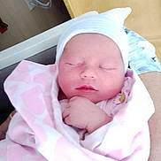 Miley joined the competition — help win amazing prizes! newborn, baby, sleeping, blanket, pink, hat, infant, wrapped, cute, peaceful, child, person, indoors, soft, closeup, face, hand, resting, cozy, portrait