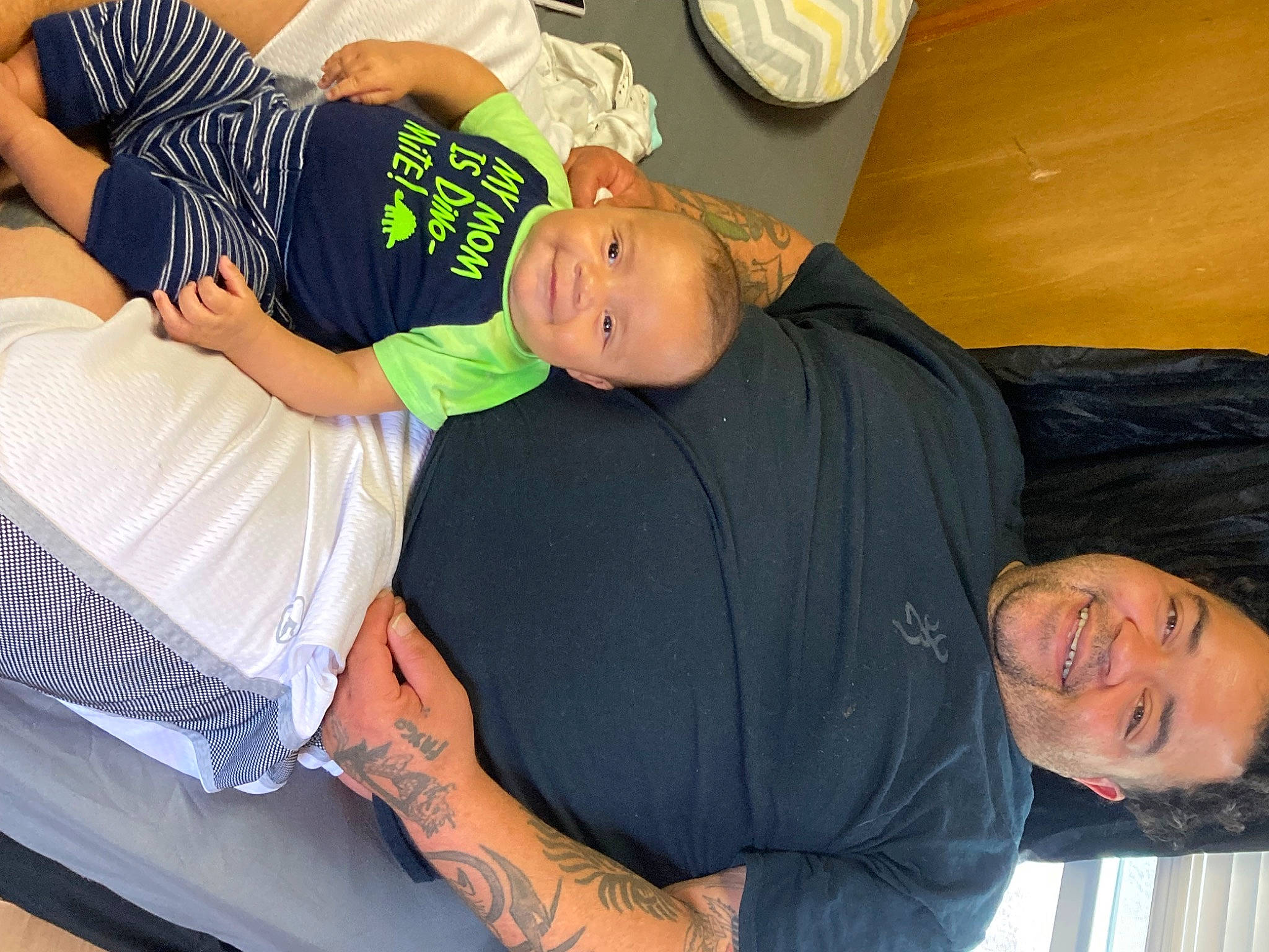 Jason is registered to the contest to win money with this photo: abdomen, chest, child, comfort, elbow, fun, happy, hat, human_leg, joint, joy, knee, lap, muscle, person, shorts, sitting, sleeve, t_shirt, thigh