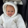 Lauren joined the competition — help win amazing prizes! baby, child, toddler, hooded_jacket, white_clothing, smile, face, blue_eyes, stroller, seatbelt, winter_wear, cute, outdoor, warm_clothing, fluffy, fur_hood, infant, person, portrait, cozy