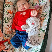 Olivia a rejoint le concours — aidez-le/la à gagner de superbes lots ! baby, infant, smiling, red_sweater, blue_pants, stuffed_animal, plush_toy, cushion, animal_print, deer, rabbit, pink_pacifier, white_shoes, toy_doll, child, indoor, cute, portrait, happy, lying_down