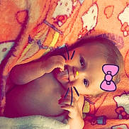 Evelynn joined the competition — help win amazing prizes! baby, blanket, cartoon, colorful, cute, digital_filter, face, hand, infant, lying_down, nostalgia, pink_bow, playful, portrait, skin, tongue_out, whiskers, young_child, cozy, wrapped