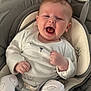 Tommy is registered to the contest to win money with this photo: baby, infant, smiling, happy, cute, pajamas, bear_pattern, baby_seat, cushion, comfort, indoor, child, young, face, hands, clothing, seatbelt, expression, portrait, relax