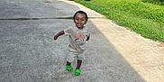 Marcus joined the competition — help win amazing prizes! toddler, child, running, smiling, green_shoes, shorts, tshirt, driveway, car, lime_green, grass, trees, house, daytime, outdoor, sunny, happy, person, nature, residential