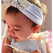 Ashley is registered to the contest to win money with this photo: child, toddler, headband, sunglasses, curious, closeup, soft_light, baby, clothing, portrait, cute, indoor, hand, face, skin, eyelashes, earring, fashion, ruffle, playful