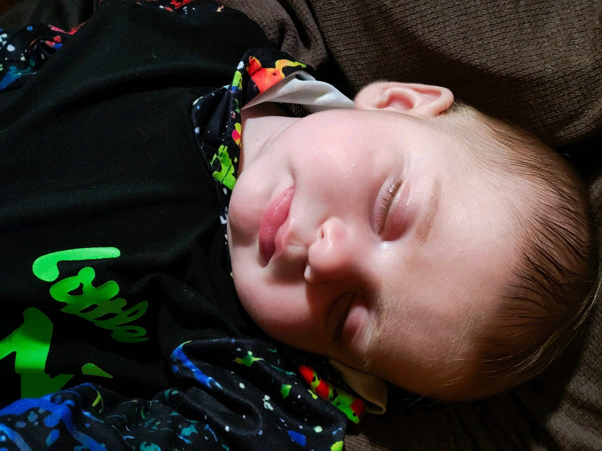 Alex is registered to the contest to win money with this photo: audio_equipment, baby, baby_toddler_clothing, black_hair, cheek, child, comfort, eyelash, eyewear, grass, green, lip, mouth, nose, pattern, person, personal_protective_equipment, product, skin, sleeve