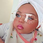 Sky is registered to the contest to win money with this photo: baby, towel, bib, glasses, earrings, face, child, portrait, indoor, cute, fashion, accessories, toddler, clothing, closeup, expression, skin, headwear, eyewear, person