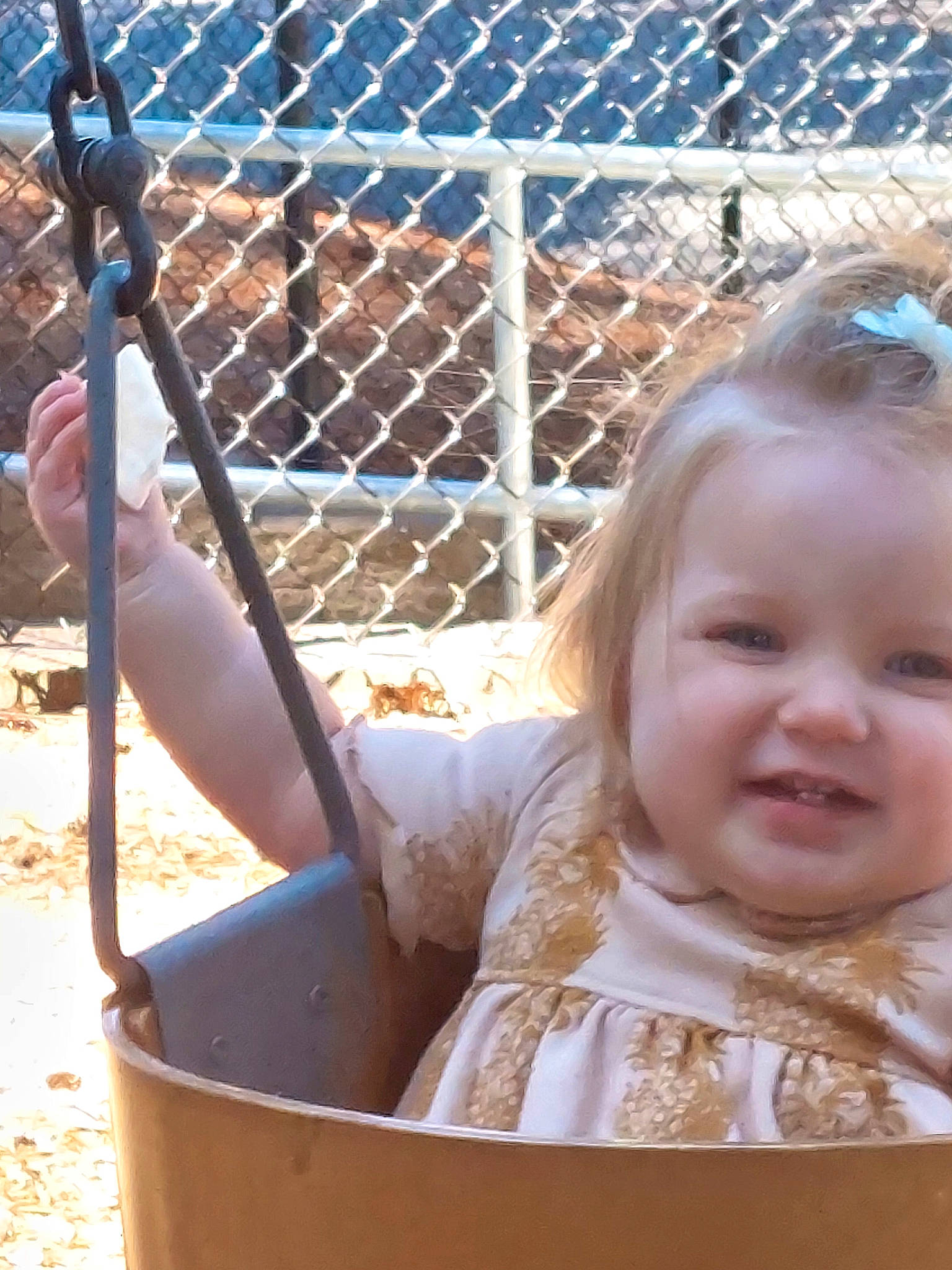 Nevaeh is registered to the contest to win money with this photo: baby, baby_products, baby_toddler_clothing, chain_link_fencing, child, fence, fun, grass, happy, leisure, mesh, metal, people_in_nature, person, recreation, sitting, smile, soil, toddler, wire_fencing