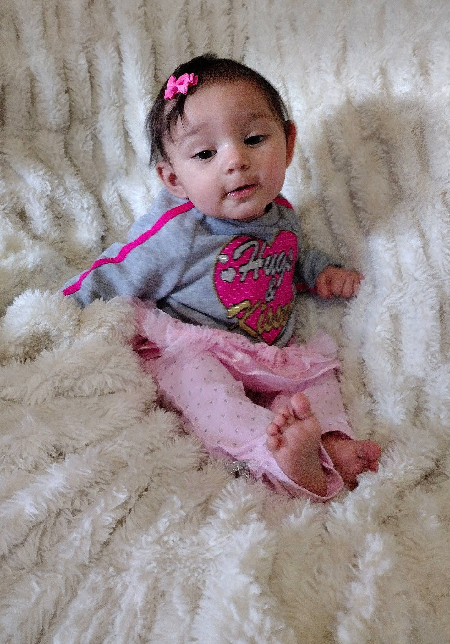 Jade is registered to the contest to win money with this photo: baby, baby_toddler_clothing, cheek, child, dress, eye, face, fashion_accessory, flooring, head, headgear, linens, magenta, pattern, person, pink, sitting, skin, sleeve, toddler