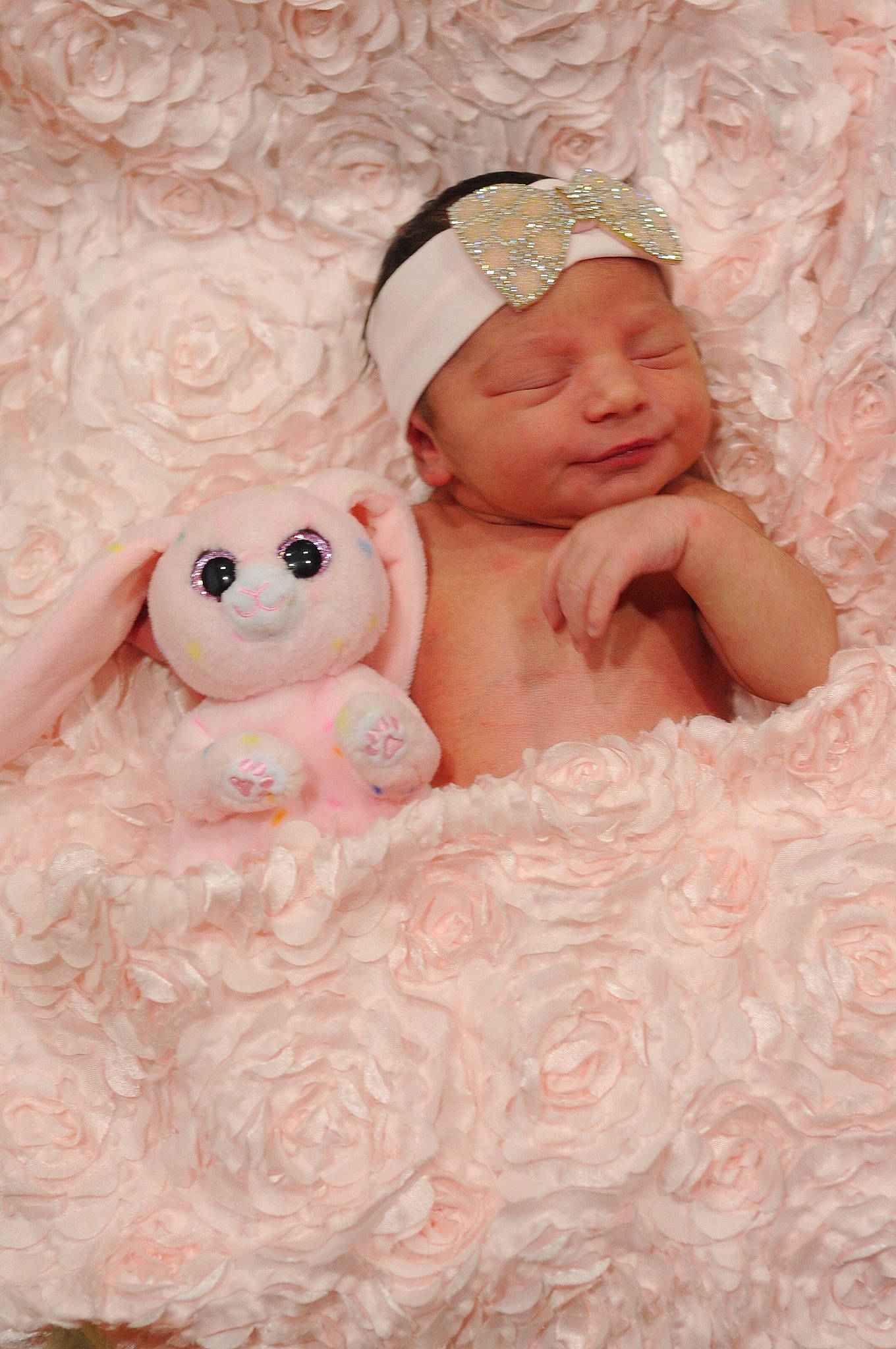 Jade is registered to the contest to win money with this photo: baby, baby_sleeping, bedding, cap, child, comfort, fur, happy, headpiece, headwear, linens, peach, person, pink, plush, room, skin, smile, stuffed_toy, teddy_bear