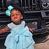 Mariah is registered to the contest to win money with this photo: black_car, blue_dress, bow, car, child, cute, dress, fashion, girl, hair_bow, happy, luxury_car, mercedes, outdoor, pavement, playful, portrait, smile, standing, vehicle