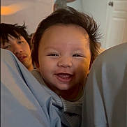 Kenai is registered to the contest to win money with this photo: adult, baby, bed, blanket, candid, child, closeup, door, face, hair, happy, indoor, infant, person, pillow, portrait, sheets, sibling, smiling, wall