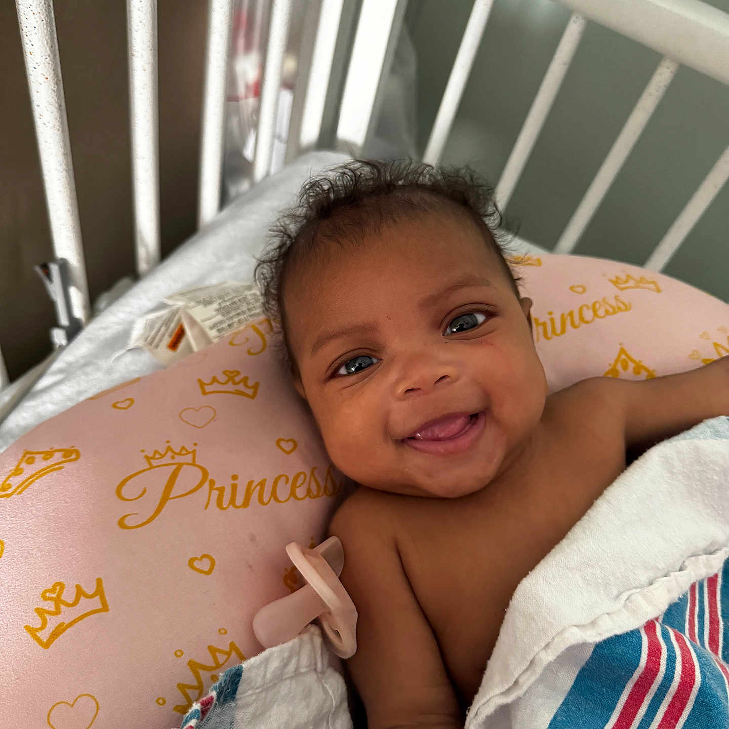 Nalyla joined the competition — help win amazing prizes! baby, blanket, child, crib, cute, expression, eyes, face, happy, head, hospital, indoors, infant, lying_down, pacifier, pillow, portrait, skin, smiling, young_child