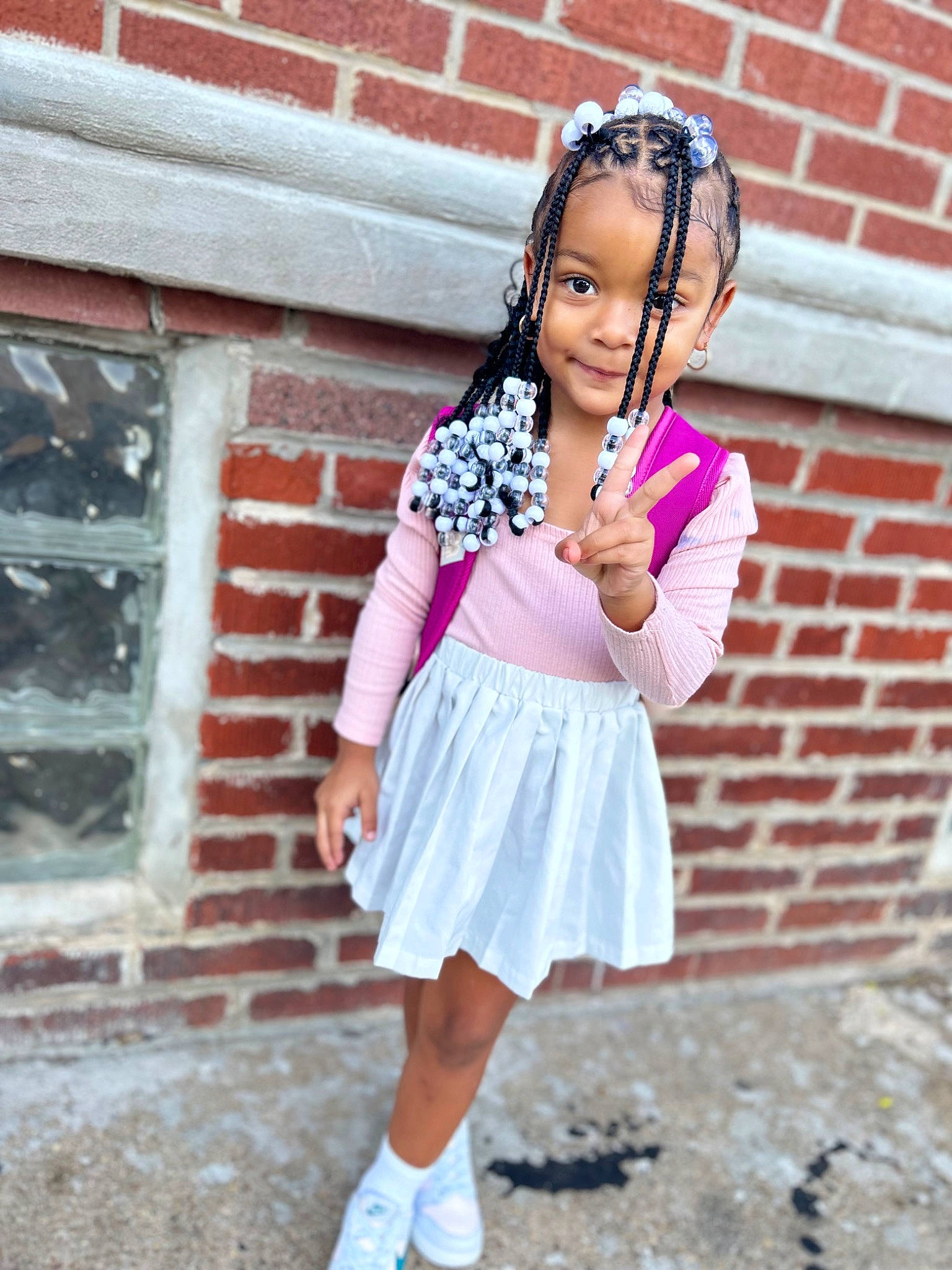 Legacy is registered to the contest to win money with this photo: arm, brick, brickwork, electric_blue, hairstyle, happy, human_leg, jewellery, knee, magenta, outerwear, person, pink, purple, shoulder, sleeve, smile, sock, thigh, toddler